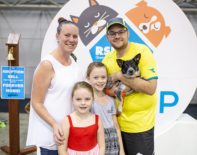 Family posing with their new adopted dog 